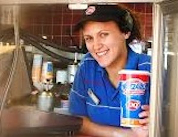 Person in drive through window holding DQ Blizzard