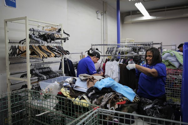 Two people sorting items in backroom