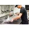 Person rinsing a baking pan