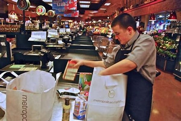 Person bagging groceries into shopping bags