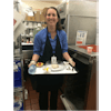 Dietary Aide holding a dinner tray