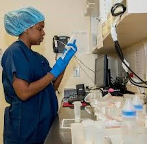 Person wearing scrubs working in a medical lab