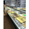 Bakery case with clear glass windows and yellow trays displaying assorted pastry and cookies.