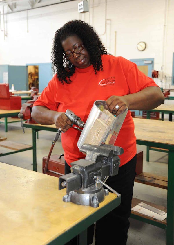 Person drilling a hole into a metal part