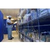 Person wearing scrubs checking inventory in medical supply warehouse