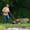 Person mowing grass with push mower