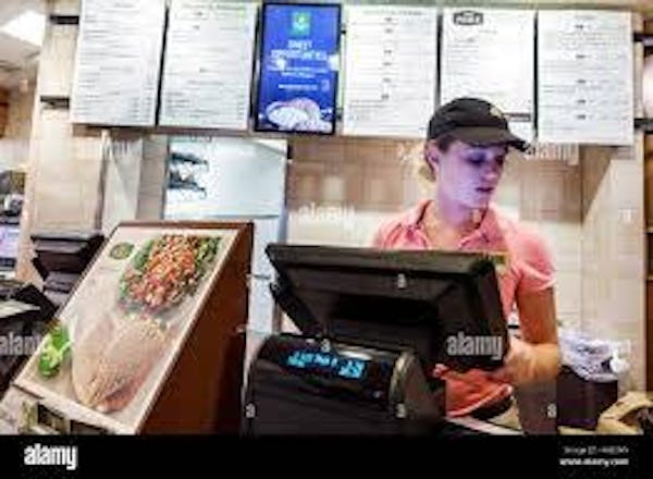 Person looking to the side while on a Point-Of-Service System in a Panera Cafe