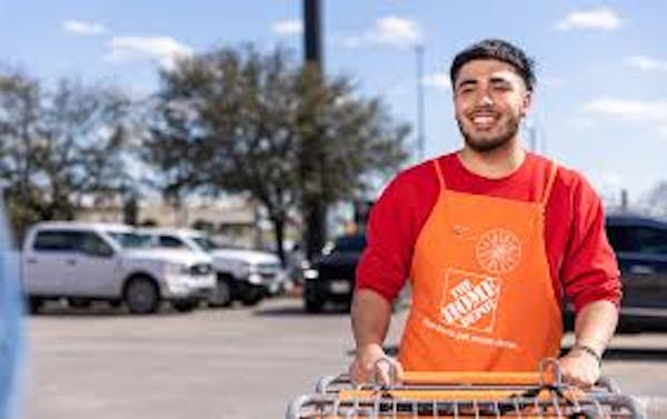 Person in Home Depot Apron pushing carts