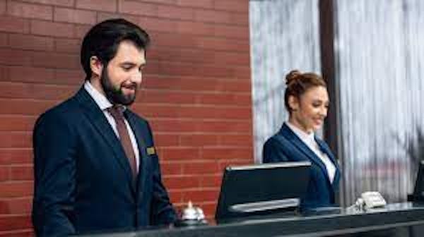 Two staff at a hotel front desk